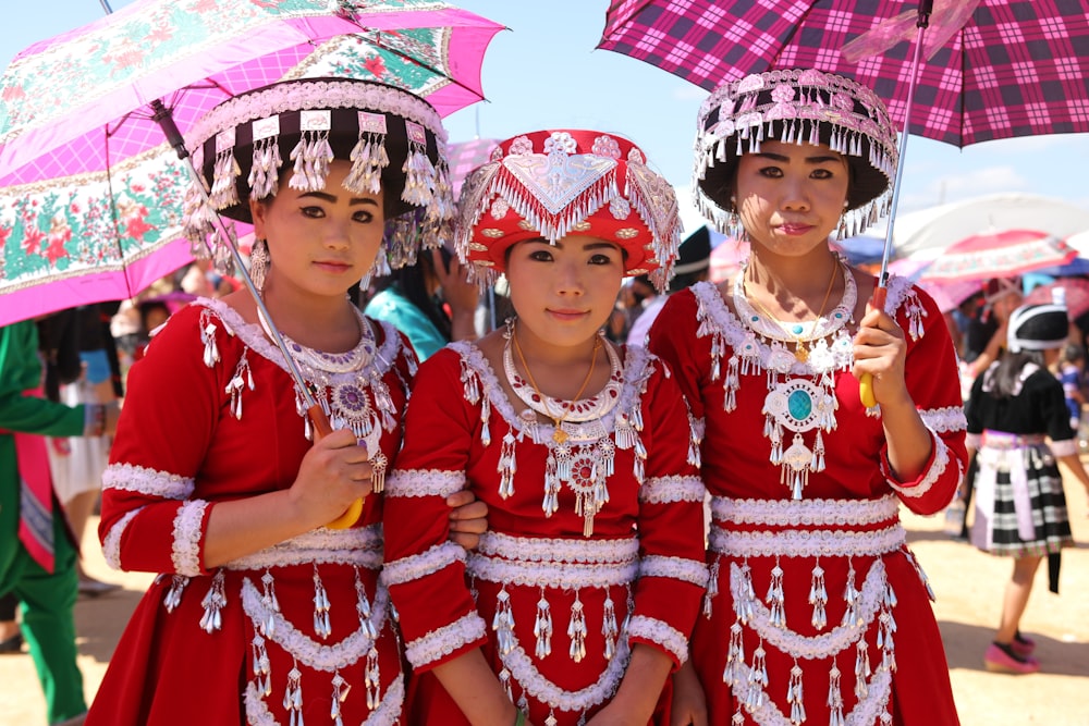 a group of young women standing next to each other under umbrellas