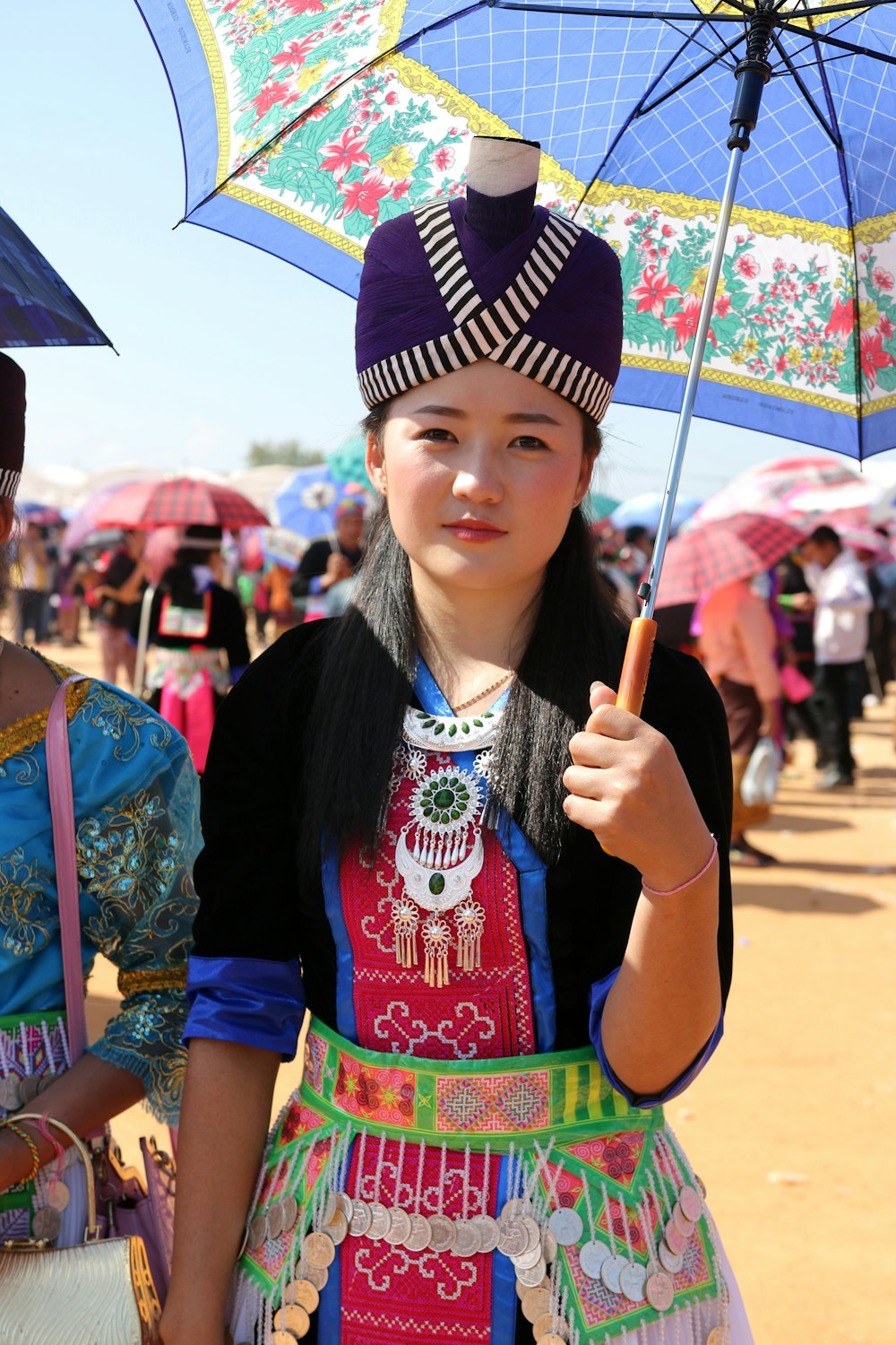 a woman in a colorful dress holding an umbrella