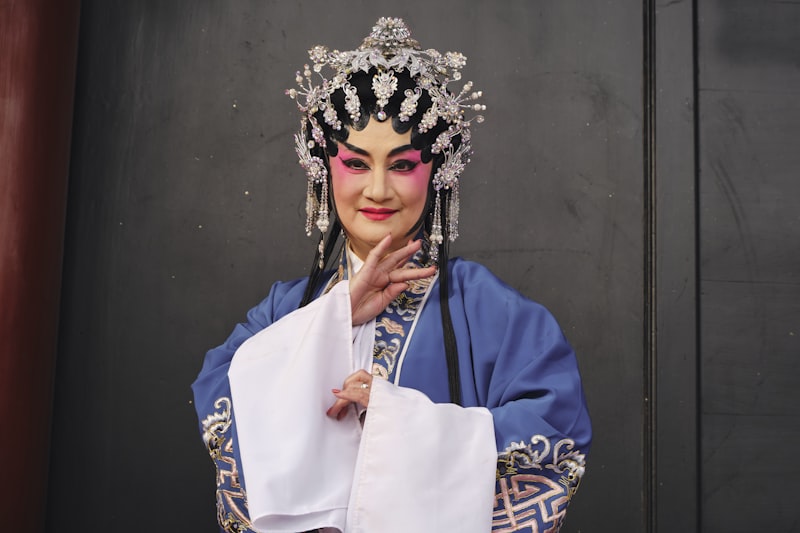 a woman dressed in a chinese costume poses for a picture
