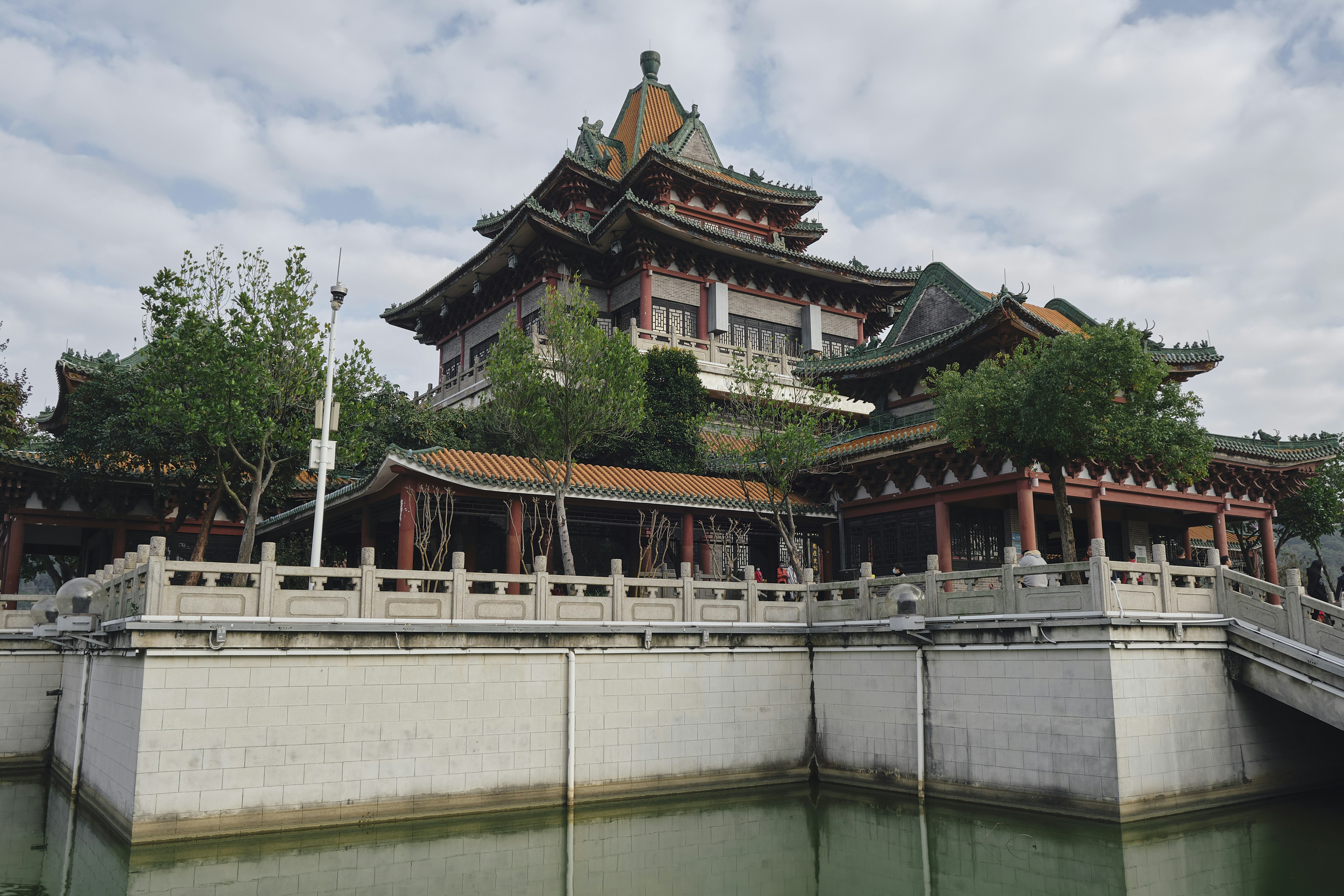 a bridge over a body of water with a building in the background