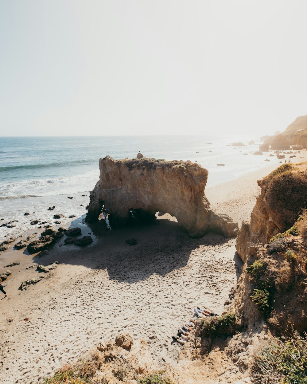 a person standing on a beach next to the ocean