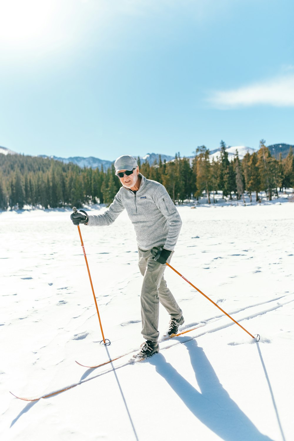 a man riding skis down a snow covered slope