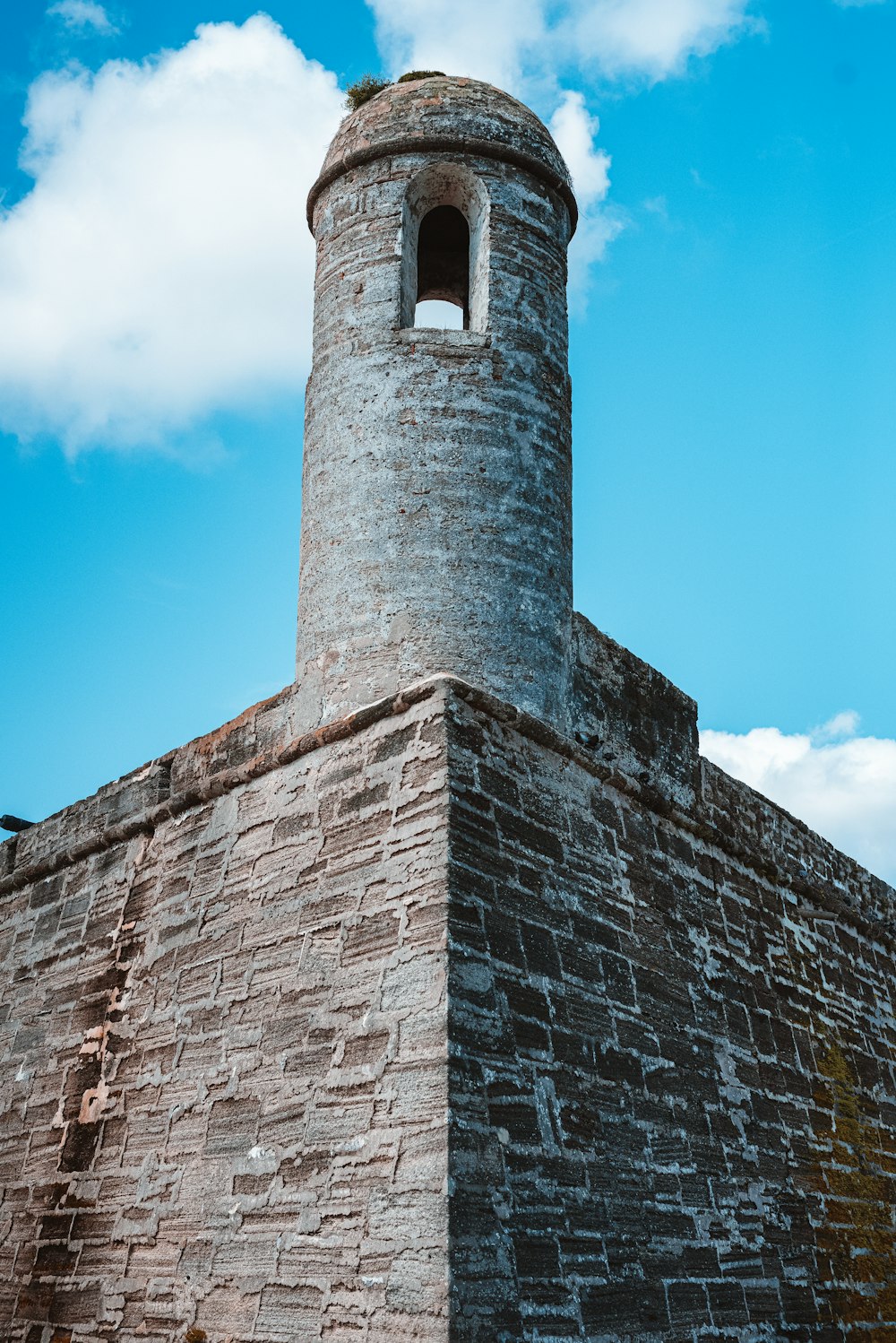 a tall brick tower with a clock on top