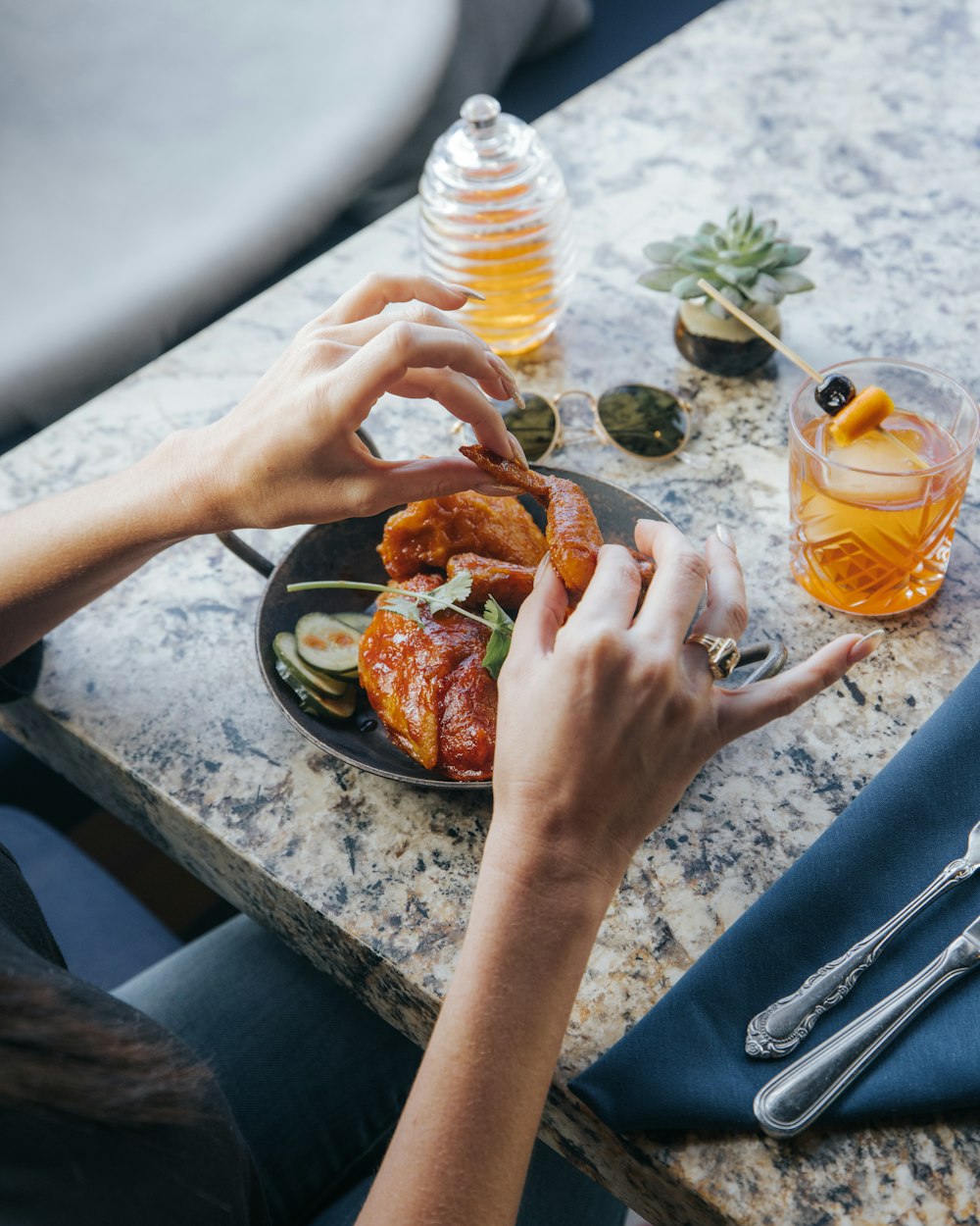 a person sitting at a table with a plate of food