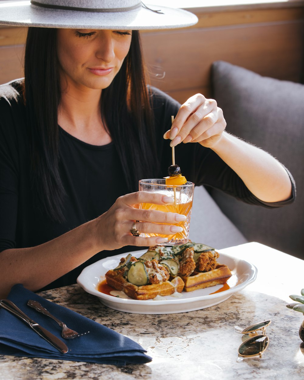 a woman sitting at a table with a plate of food