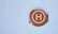 a circle with the letter h on it in the snow