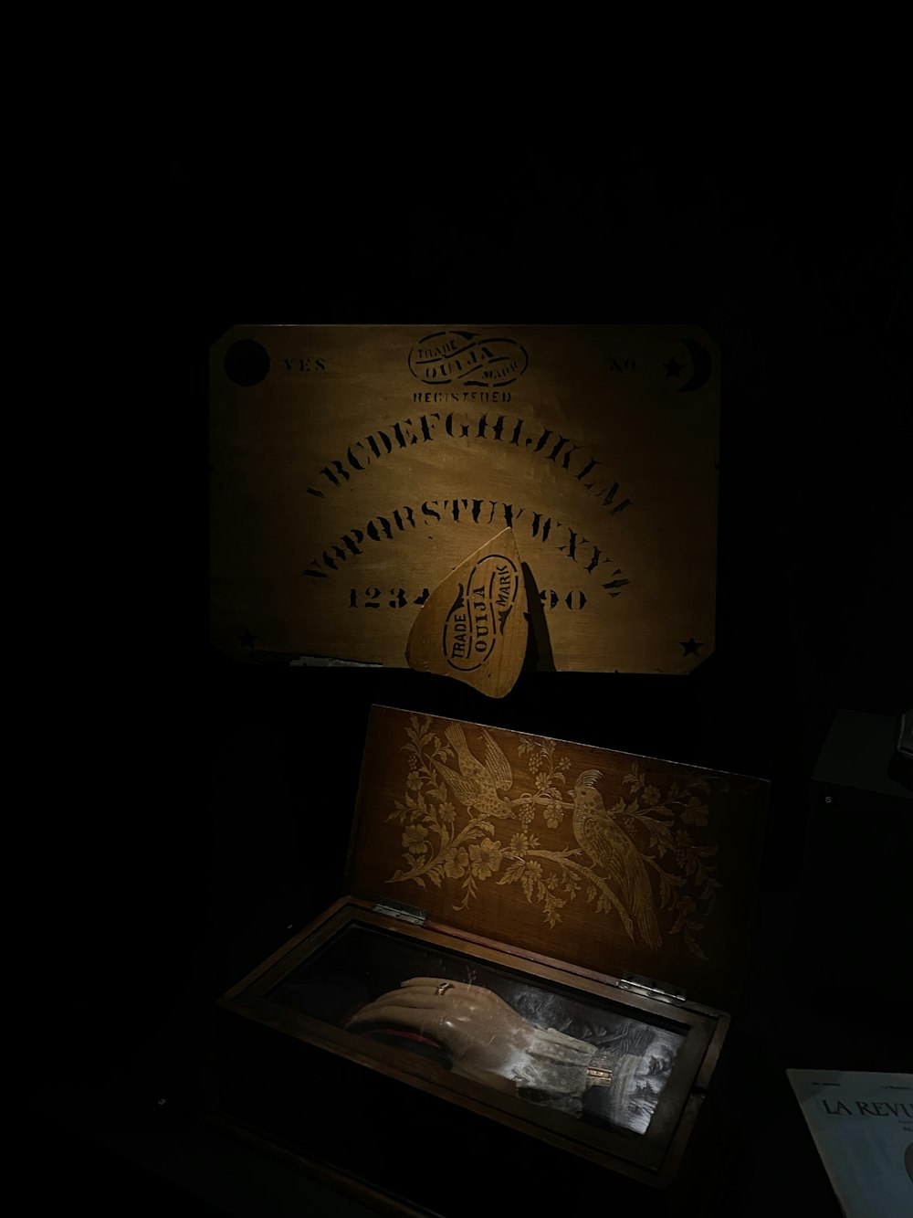 a dark room with a wooden box and a light