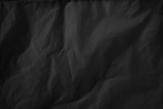 A subtle shadow texture with faint red veins weaving through a deep matte black background.