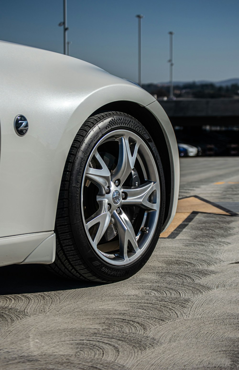 a white sports car parked in a parking lot