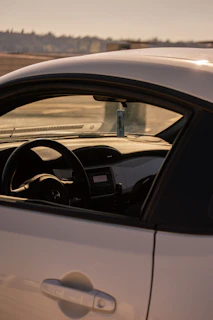 Close-up of a sleek car dashboard with a 'Sold' tag hanging from the rearview mirror.