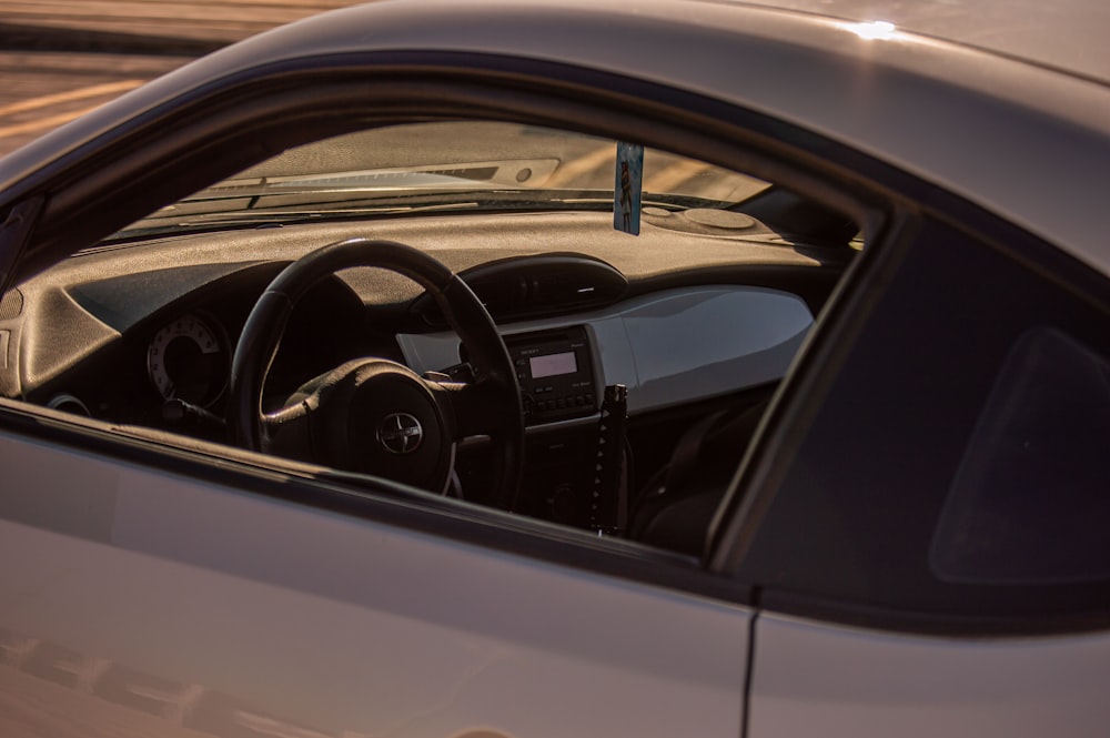 a close up of a car's steering wheel and dashboard