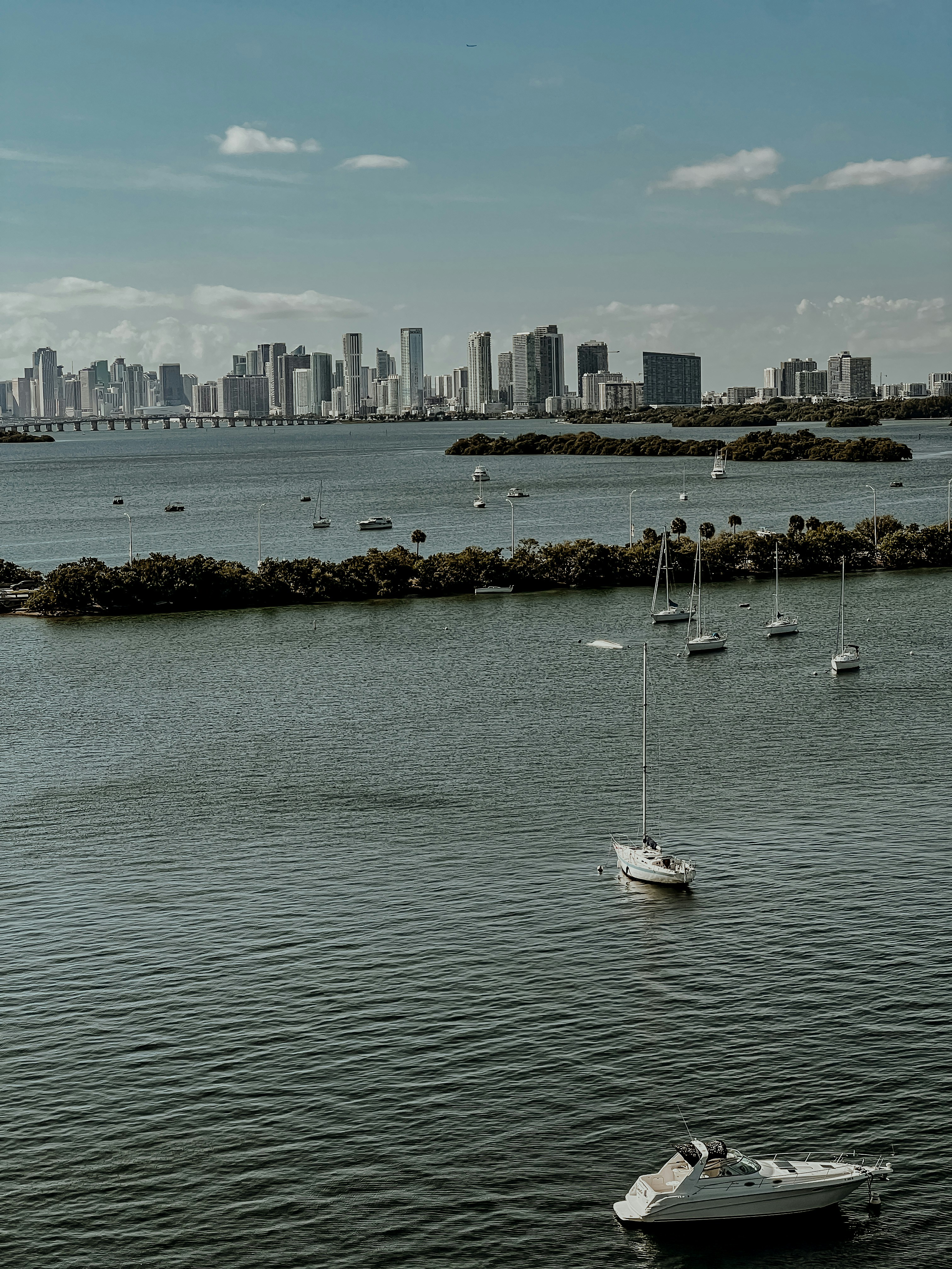 a body of water with boats in it and a city in the background