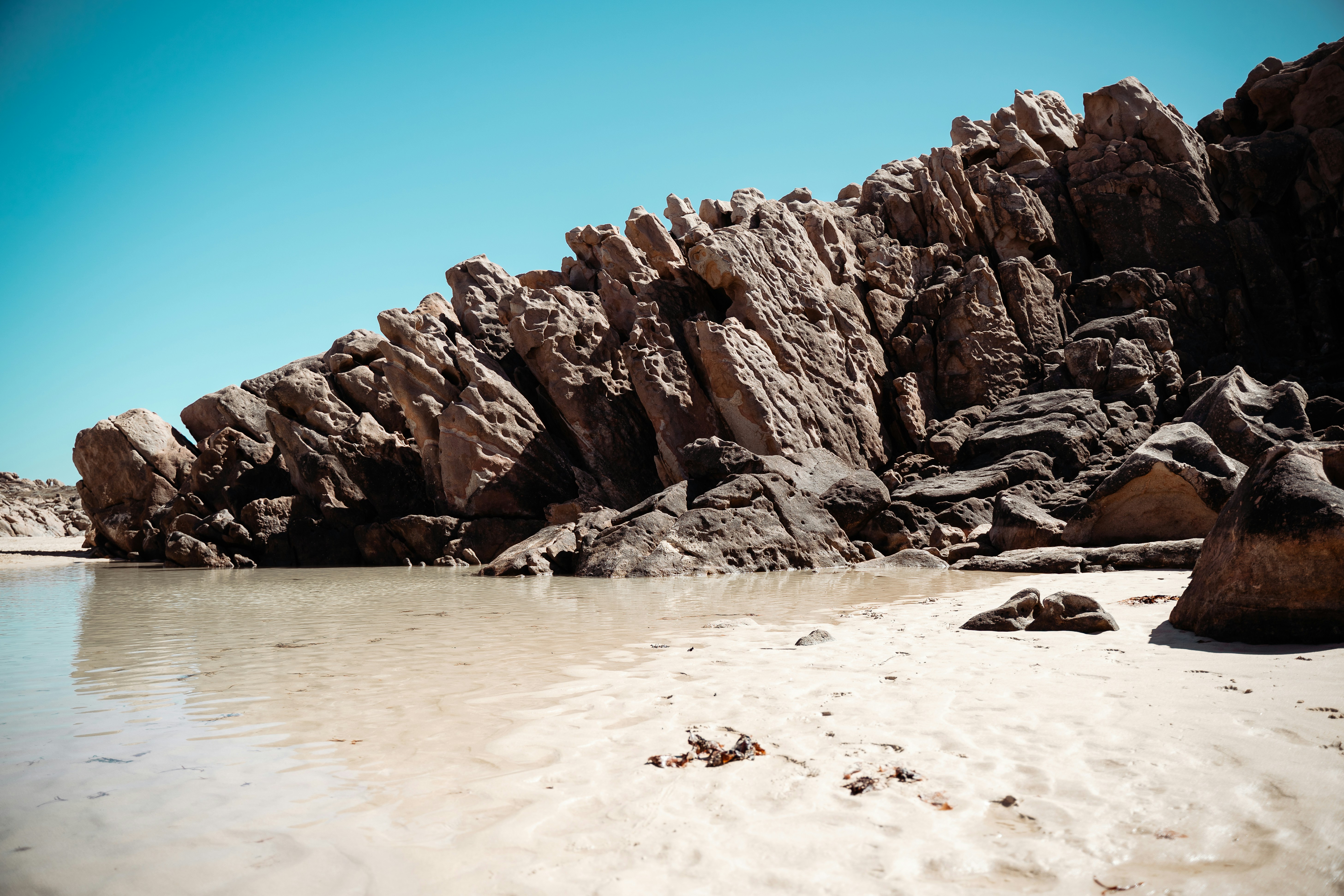 a beach with rocks and a body of water