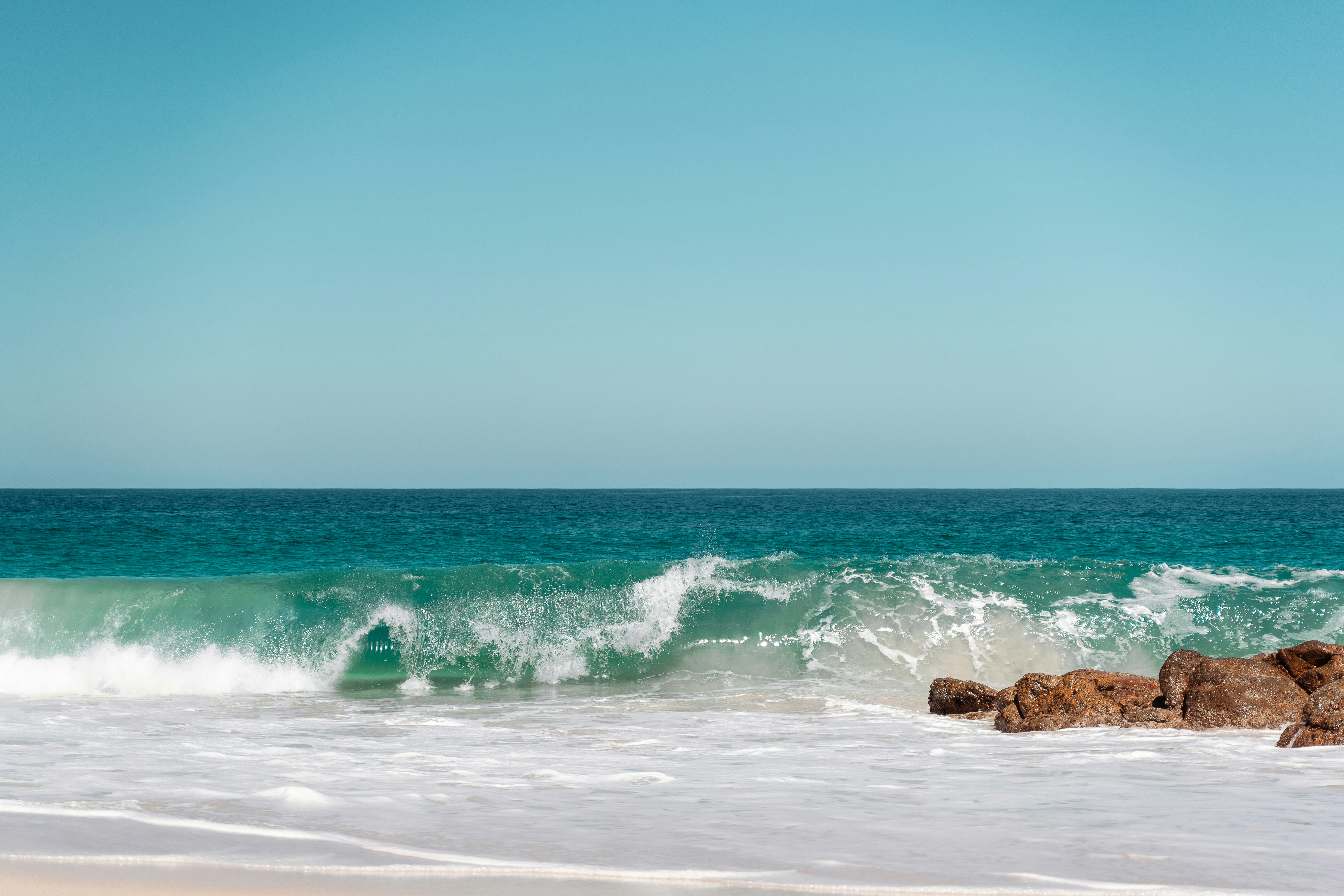 A person riding a surfboard on top of a wave photo Free Dunsborough