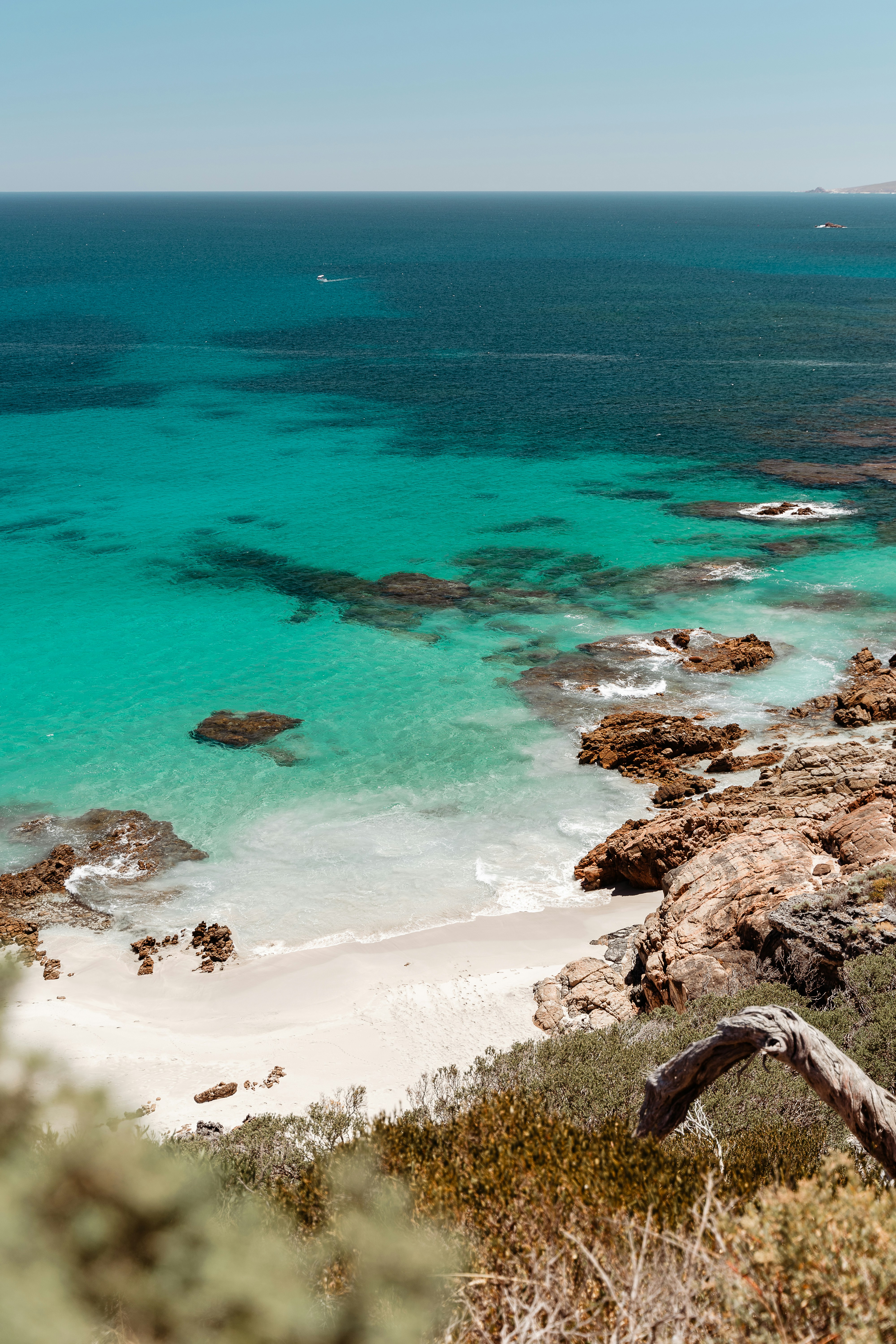 a view of a beach with clear blue water