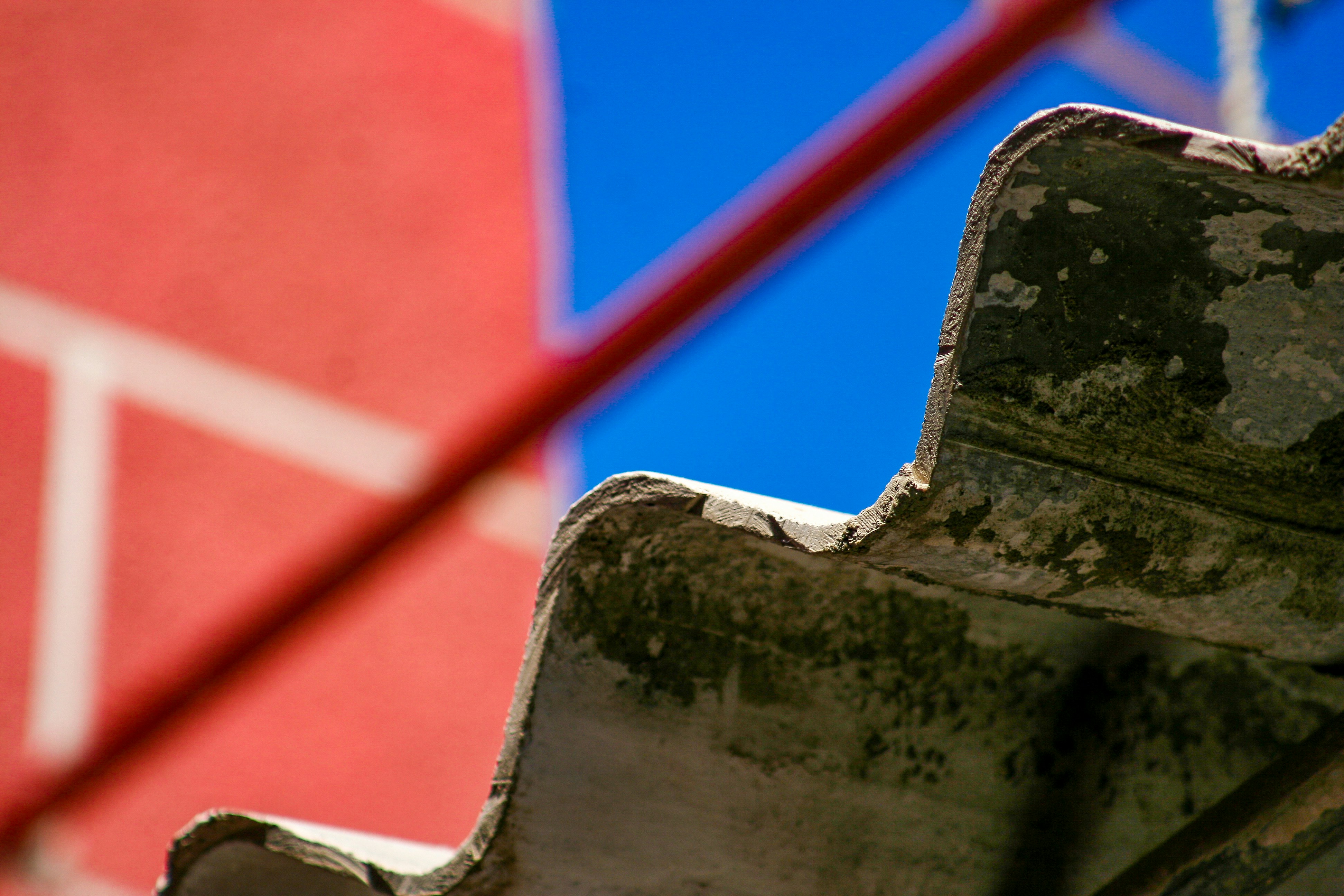a close up of a rusted bench against a blue sky