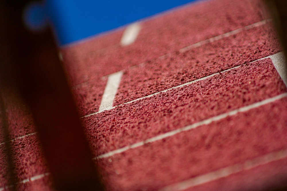 a close up of a tennis court with a blue sky in the background