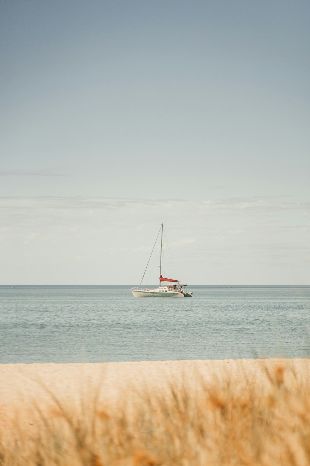 a sailboat in the ocean on a sunny day