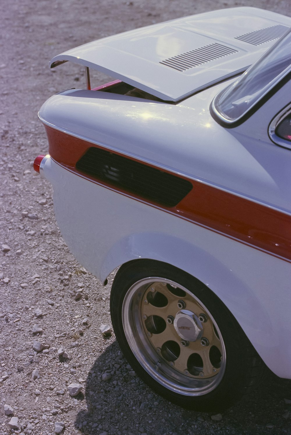 a white and red car parked in a parking lot