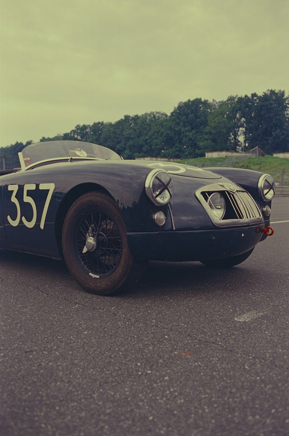 an old race car is parked in a parking lot