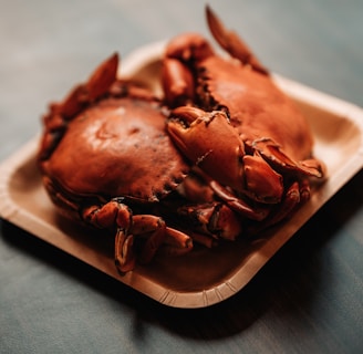 a close up of a plate of crabs on a table