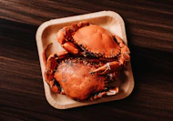 a close up of a plate of crab on a table