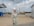 A happy customer standing in front of a completed building project by Mousin Building Contracting.
