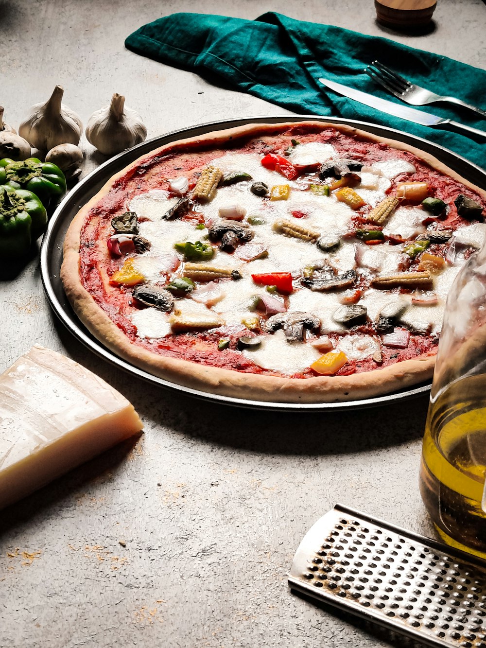 a pizza sitting on top of a pan next to a bottle of wine