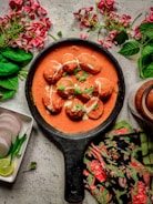 a pan filled with food next to some flowers