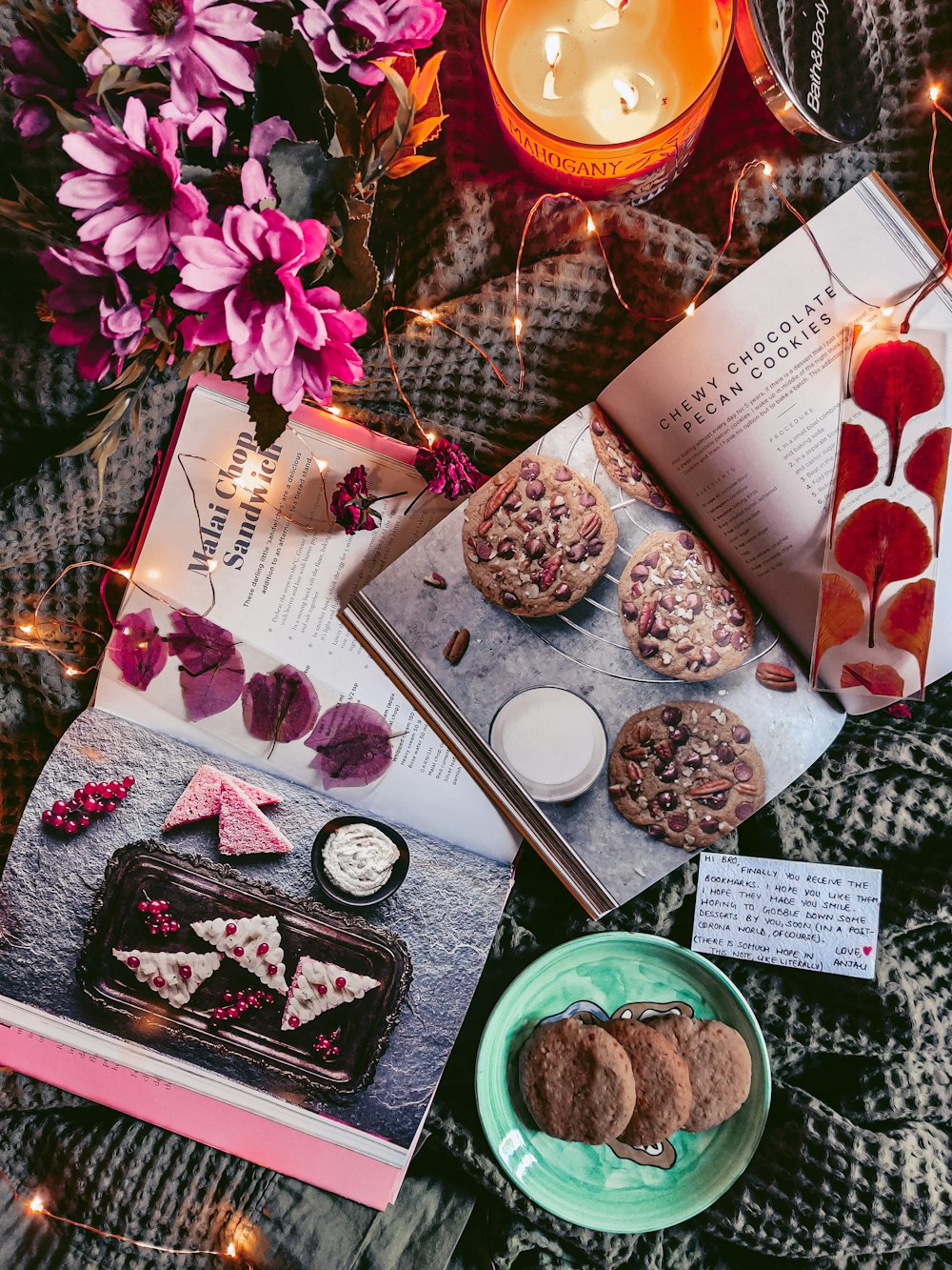 a table topped with a book and a plate of cookies