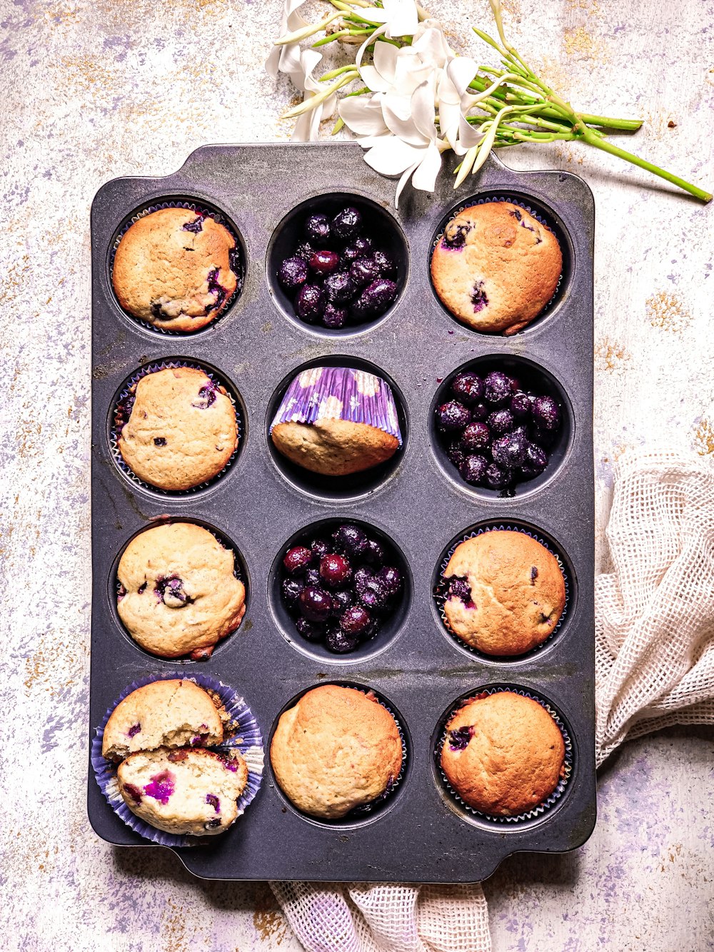 a muffin tin filled with blueberry muffins