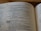 An open book displaying text from a religious scripture, specifically from the Old Testament. The verses discuss teachings and instructions from God, describing various practices including threshing. The text is in a clean, legible font with chapter and verse numbers clearly marked.