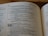 An open book displaying text from a religious scripture, specifically from the Old Testament. The verses discuss teachings and instructions from God, describing various practices including threshing. The text is in a clean, legible font with chapter and verse numbers clearly marked.
