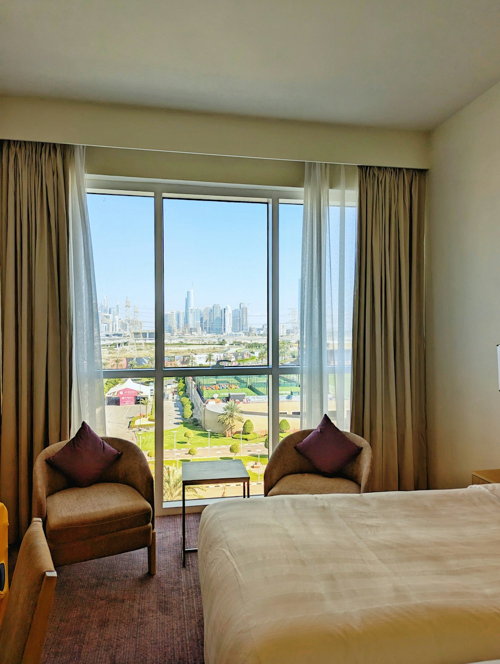 a hotel room with a view of the city