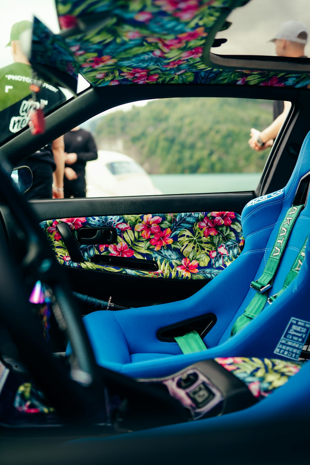 the interior of a car with a floral seat cover