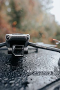 Close-up of drone equipment spraying water on a glass surface.