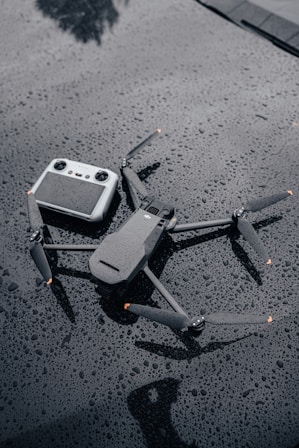 a broken camera sitting on top of a wet surface