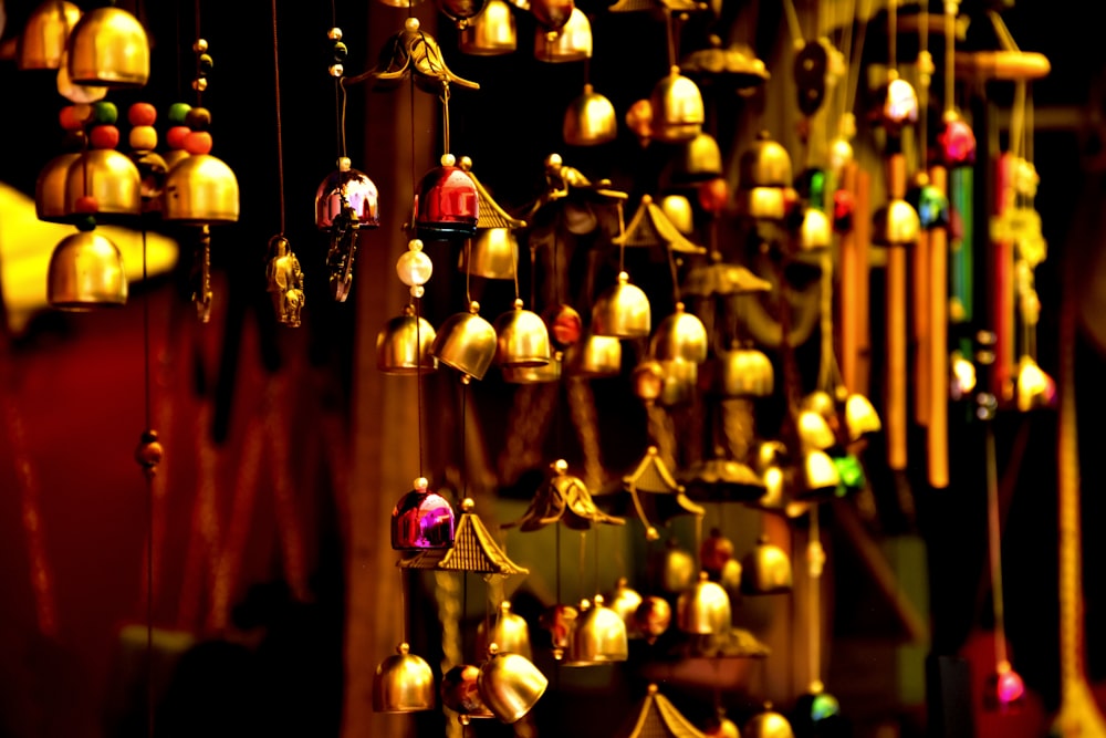 a bunch of bells that are hanging from a wall