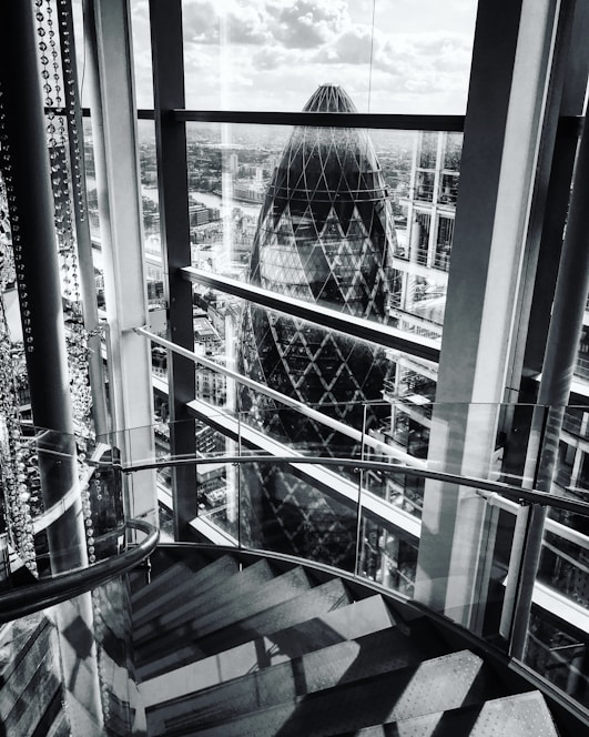 A striking high-definition photograph of a modern London building showcasing glass, concrete, and steel textures under soft natural light