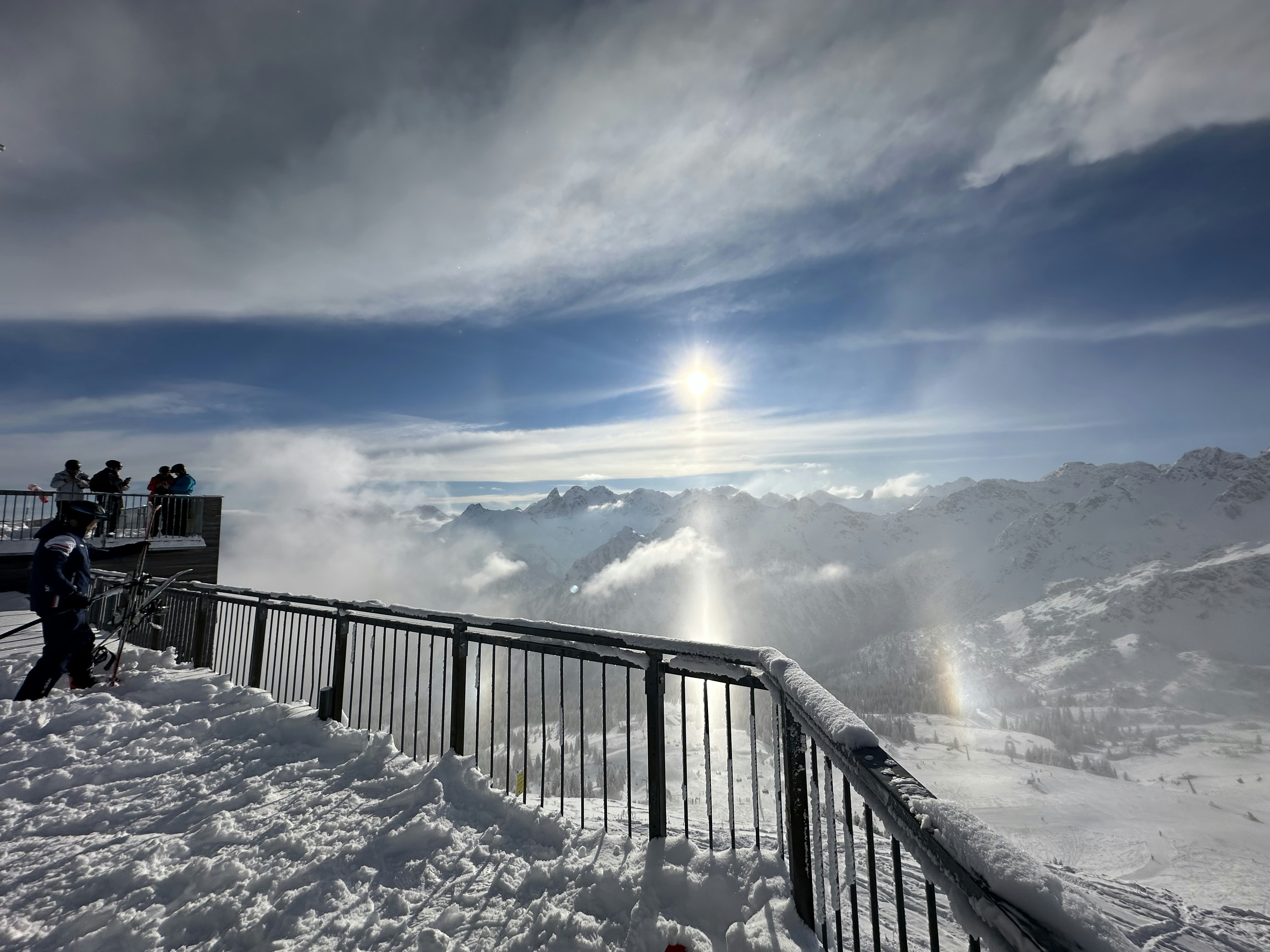 a group of people standing on top of a snow covered slope