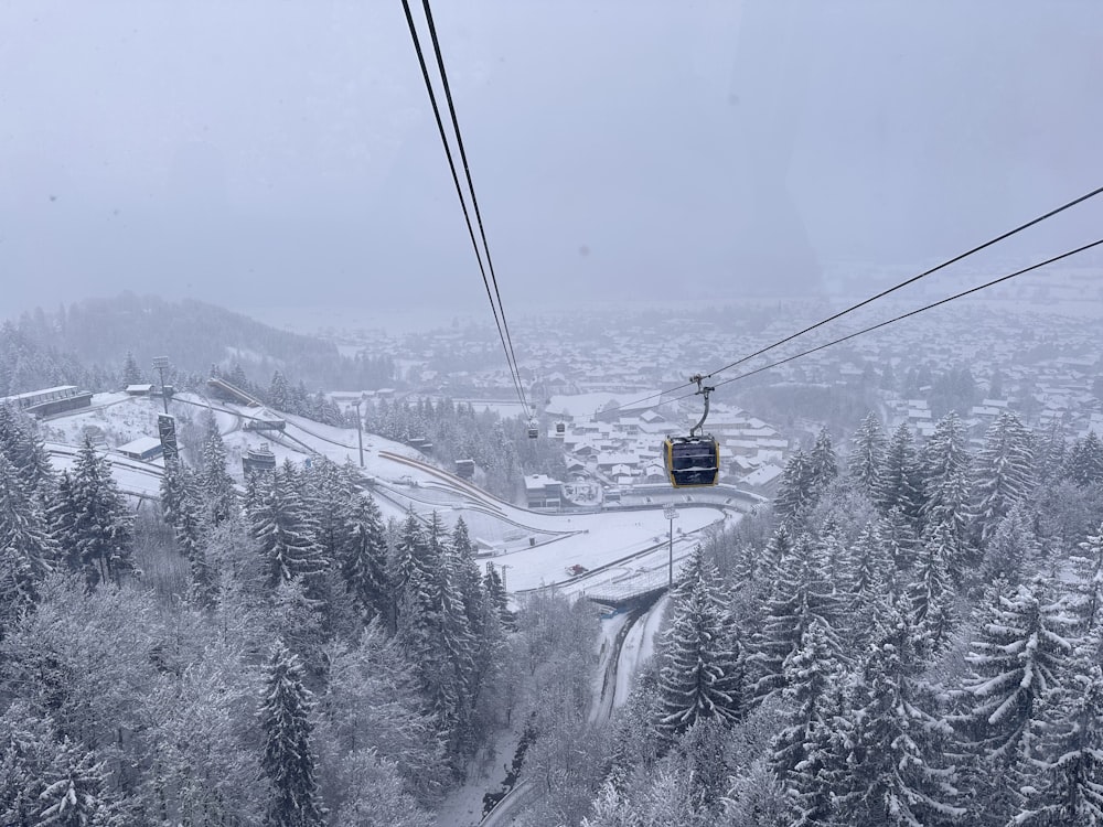 a ski lift going up a snowy mountain