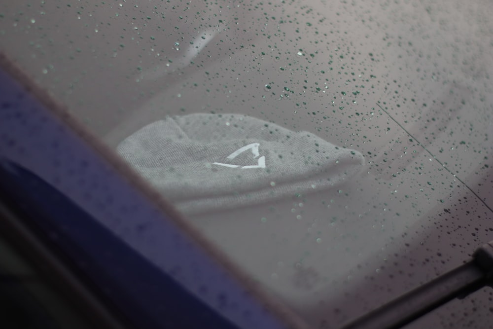 a close up of a car's windshield with rain drops