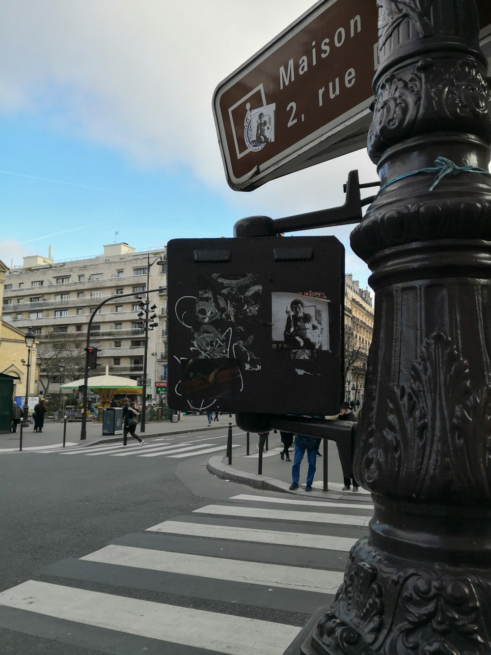 a street sign on the corner of a busy street