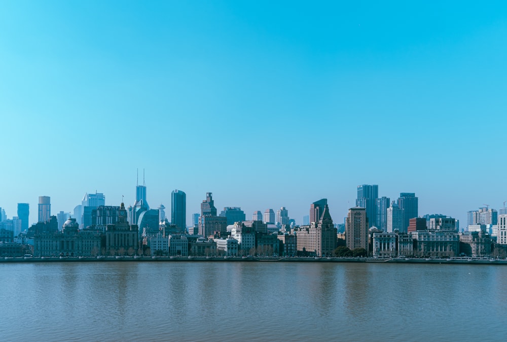 a large body of water with a city in the background