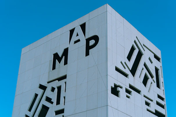 A sleek aluminum 3D letter sign mounted on a modern building facade.