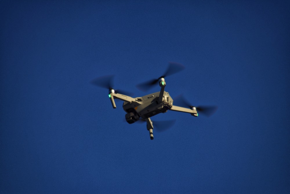 a small propeller plane flying through a blue sky