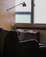 A quiet reading corner with a comfortable chair and a floor lamp.