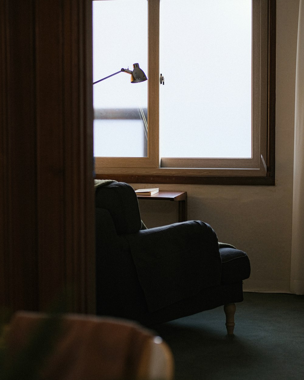 a chair sitting in front of a window in a living room