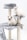 Two fluffy, light-colored kittens with blue eyes are sitting on a multi-level cat tree. The cat tree is covered in soft, gray material with rope-covered scratching posts.