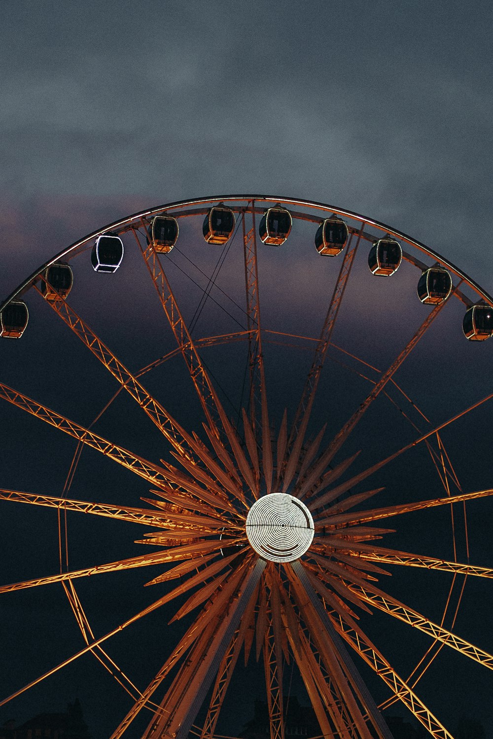 a large ferris wheel sitting under a cloudy sky